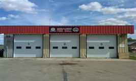 3 stall garage with white doors